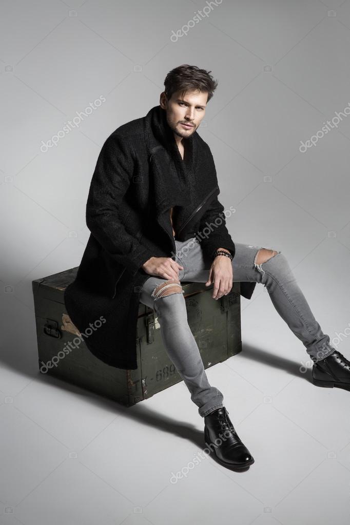 male model posing on a light background in fashionable clothes coat model  pants 22641966 Stock Photo at Vecteezy