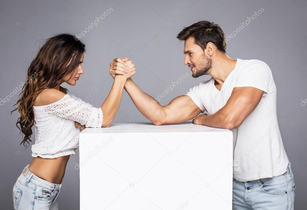 Beautiful couple doing arm wrestling challenge