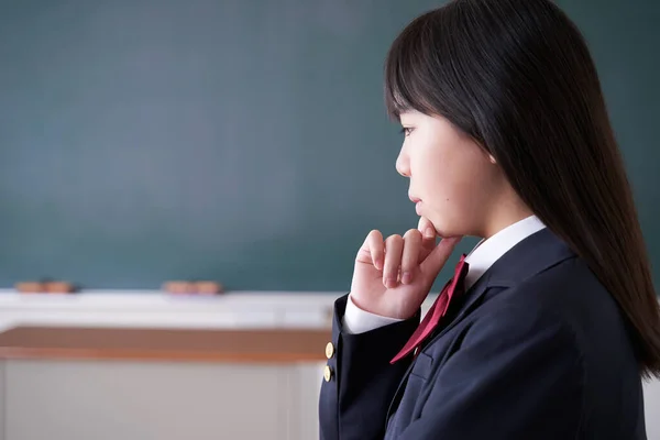 A Japanese junior high school girl struggling in her classroom