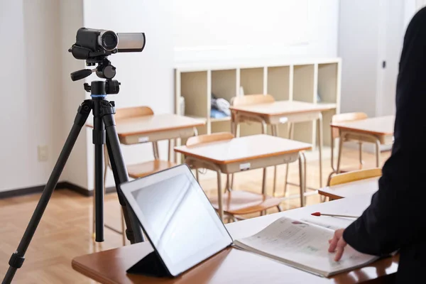 Image of filming an online class in a classroom.