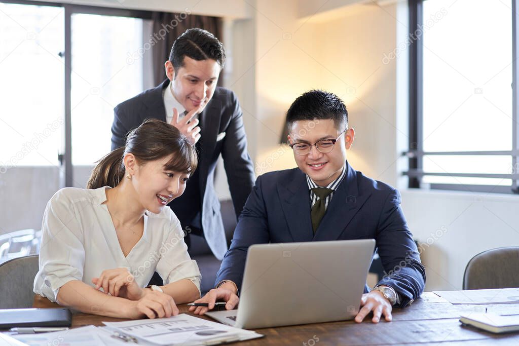 Asian and Latin business people having web conferencing on a computer