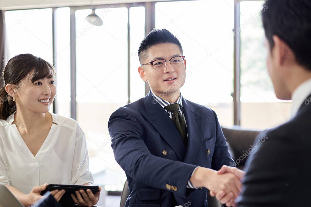 Asian businessman shaking hands with client
