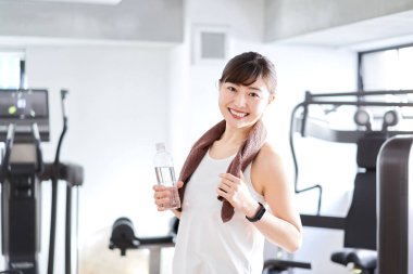 Asian woman sweating at the gym