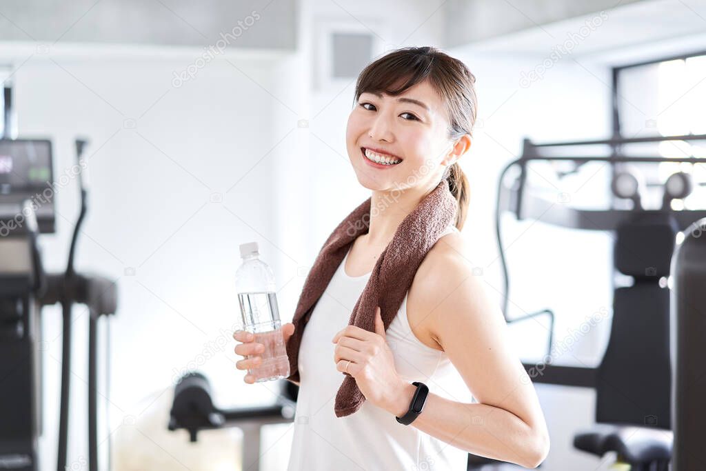 Asian woman sweating at the gym