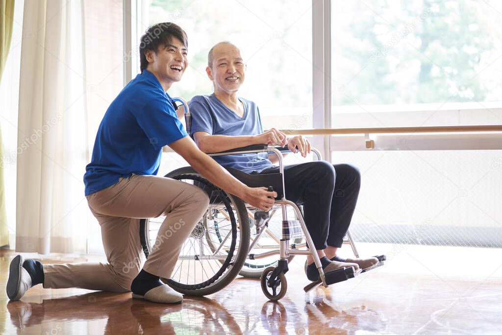 Wheelchair riding elderly and caregivers