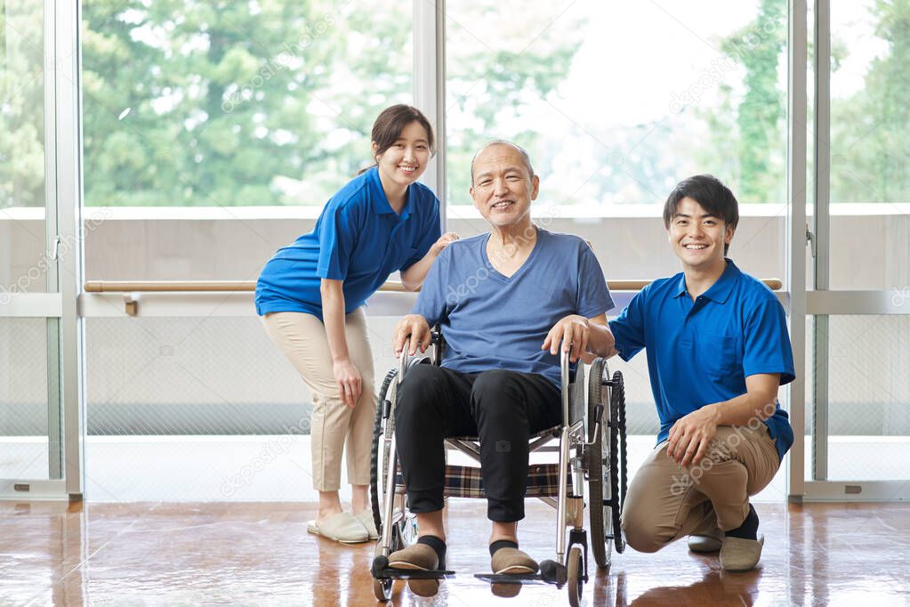 Asian elderly and male and female caregivers