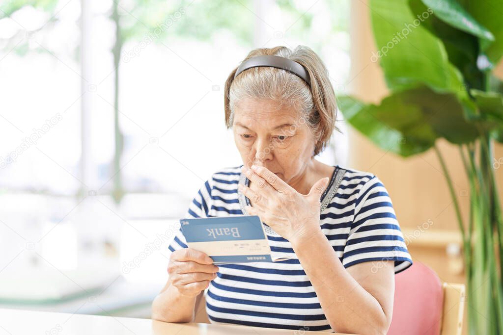 Elderly people surprised by looking at bank passbooks