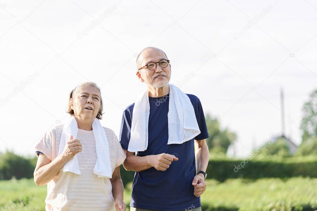 Elderly Asians jogging outside in the evening