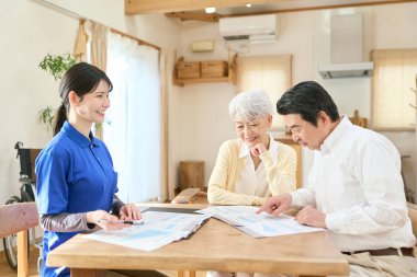 Asyalı bakıcı evde bakım sırasında planı açıklıyor