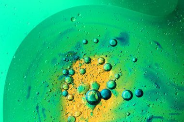 Camda su ve renkli arka planda yağ kabarcıkları