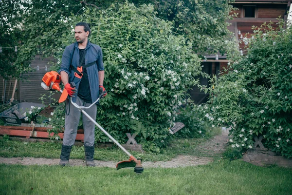 Homem Corta Relva Com Cortador Mãos Jardim Jovem Cuida Gramado — Fotografia de Stock