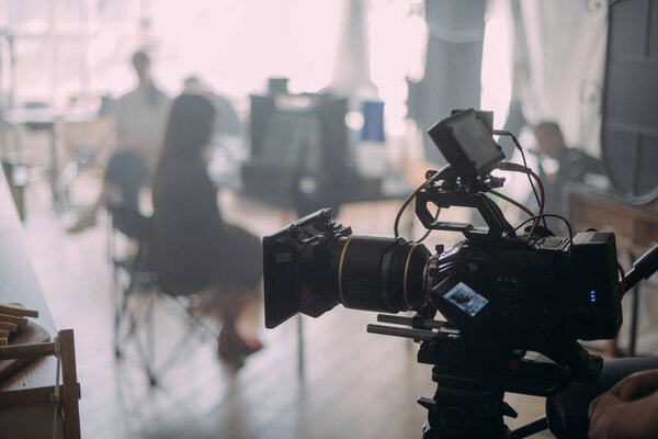 Professional cinema and video camera on the set. Shooting shift, lighting fixtures, shooting equipment and the team. Technique of modern filming and advertising.