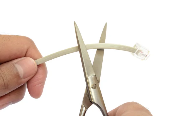 Hand cutting a phone cable — Stock Photo, Image