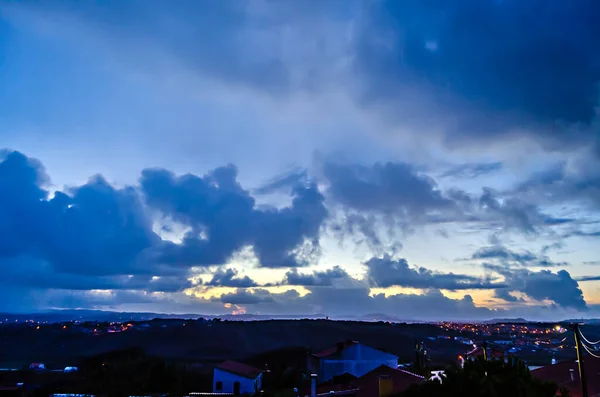 Dramatically cloudy sky in the afternoon with reflections and blue-yellow colors