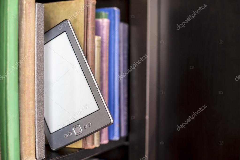 E Book Stands On A Wooden Bookshelf Stock Photo C Akoldunov