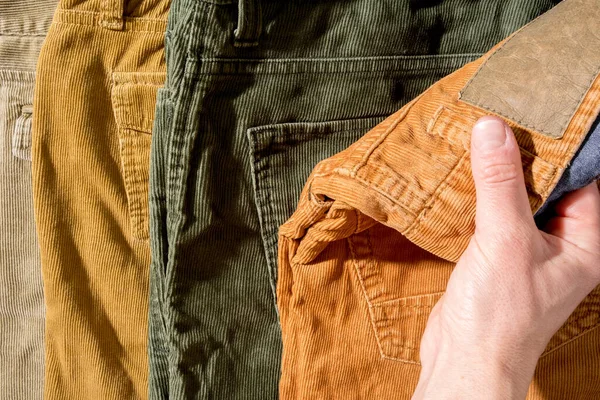 Hand grabs corduroy trousers, on sale. Shopping. — Stok fotoğraf