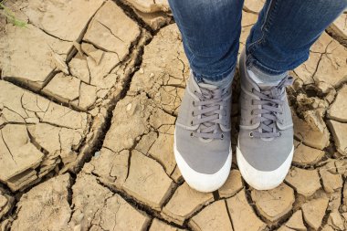 feet  standing on the chapped soil with crack