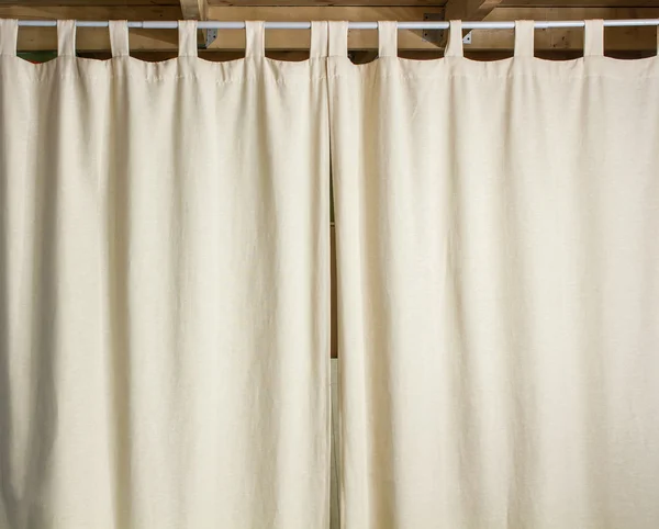 Ivory curtain hanging on a metal rod — Stock Photo, Image