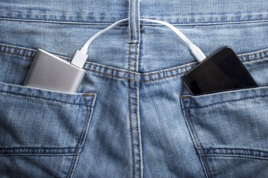 power bank lies in a back pocket of jeans the mobile phone charg clipart