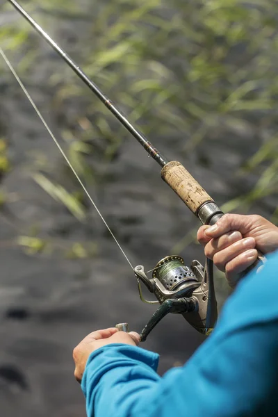 Man visserij op spinnen, zonnige dag aan het meer — Stockfoto