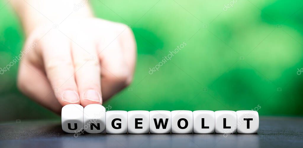 Hand turns dice and changes the German word 