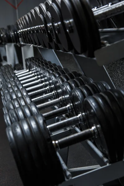 Iron dumbbells in gym — Stock Photo, Image