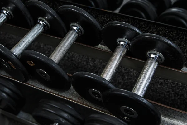 Iron dumbbells in gym — Stock Photo, Image