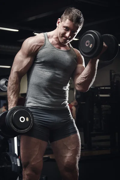 Muscular man with dumbbells — Stock Photo, Image