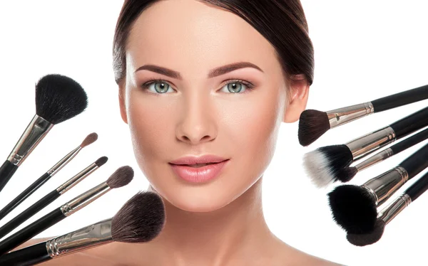 Woman face and makeup brushes — Stock Photo, Image