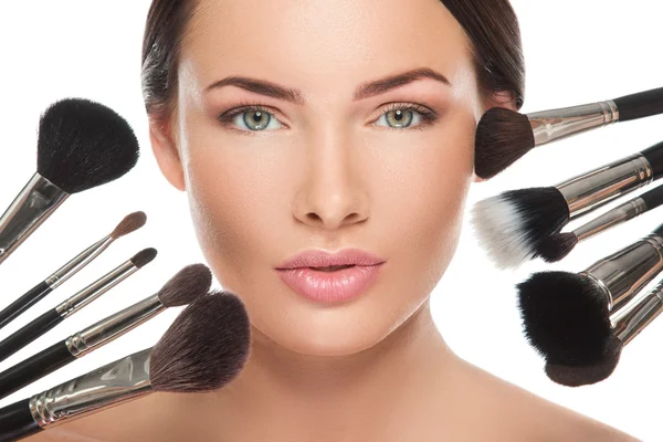 Woman face and makeup brushes — Stock Photo, Image