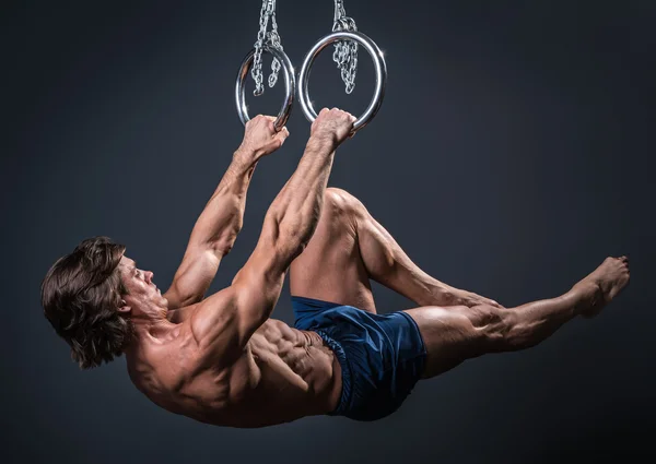 Muscular male gymnast on rings — Stock Photo, Image