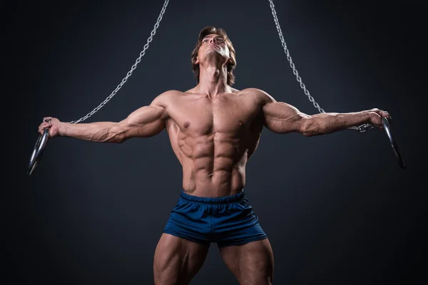 Muscular male gymnast on rings — Stock Photo, Image