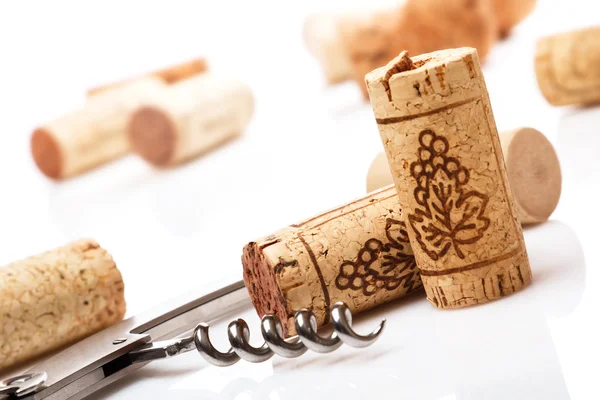 Corkscrew and wine corks — Stock Photo, Image