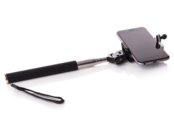Smart phone on a selfie stick — Stock Photo, Image