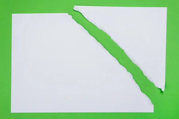 Torn paper on green background — Stock Photo, Image