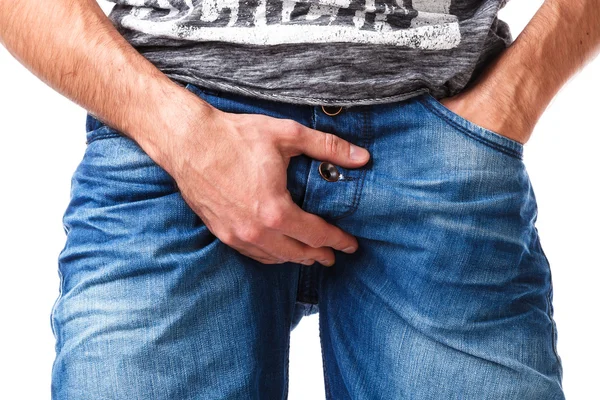 Man in jeans put his arm on groin — Stock Image Man in jeans put his arm on groin Stock Picture