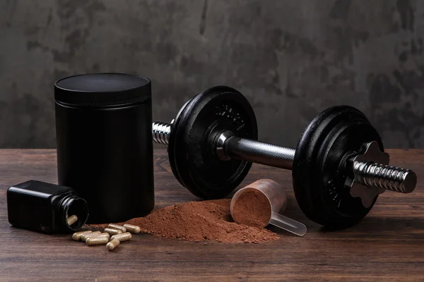 Dumbells and food supplements — Stock Photo, Image