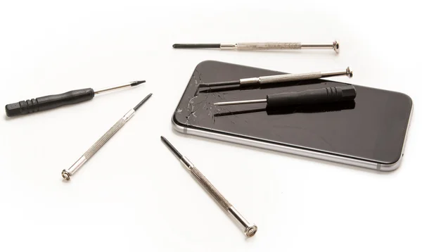 Broken smartphone and small screwdrivers — Stock Photo, Image