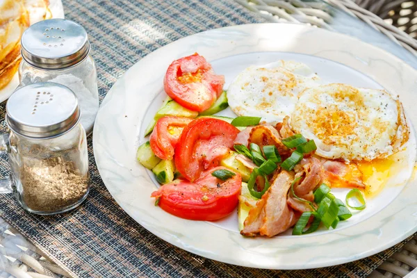 Жареные яйца с беконом и овощами — стоковое фото