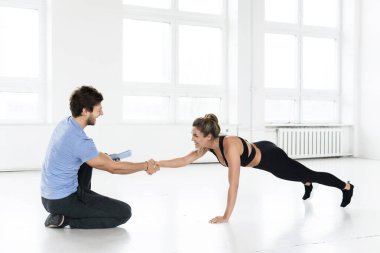 Fitness man and woman during calisthenic workout with in the gym.  clipart