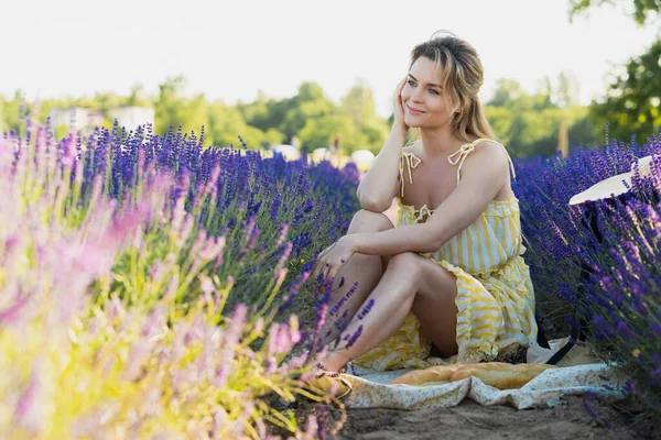 ラベンダーの花でいっぱいのフィールドで美しく若い女の子 — ストック写真