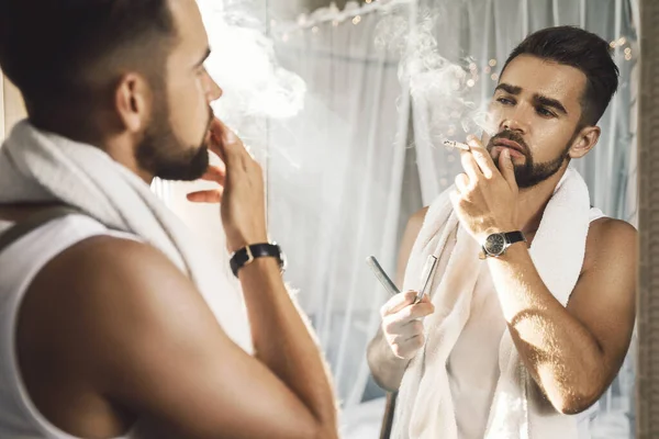 Snygg Man Som Ser Sig Spegeln Röker Cigarett Och Rakar — Stockfoto