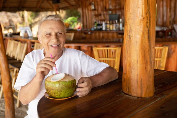 Enjoying Retirement Happy Senior Man Drinking Coconut Water Beach Bar — Stock Photo, Image