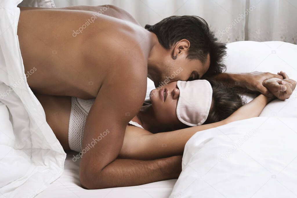 Young and beautiful couple making love in the bed