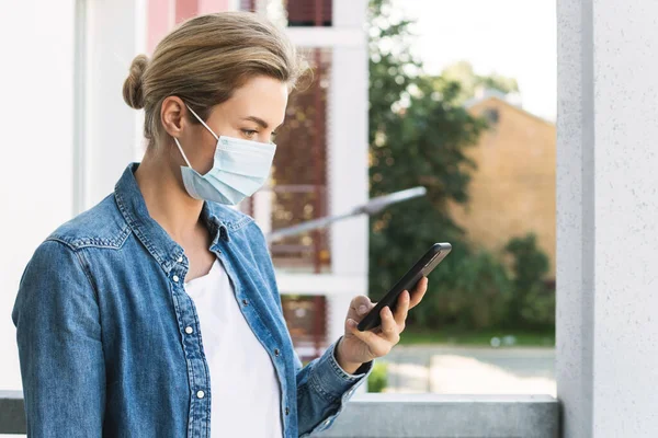 Young Woman Prevention Mask Her Face Using Smartphone — Stock Photo, Image