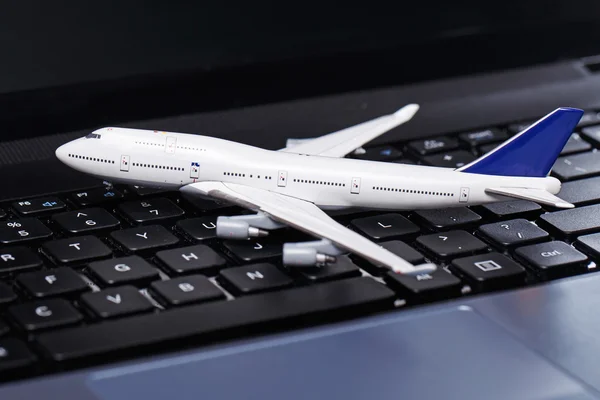 Aircraft over laptop keyboard — Stock Photo, Image