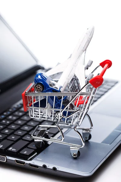 Aircraft and car in shopping trolley — Stock Photo, Image