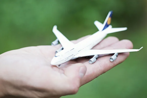 Airplane on hand — Stock Photo, Image