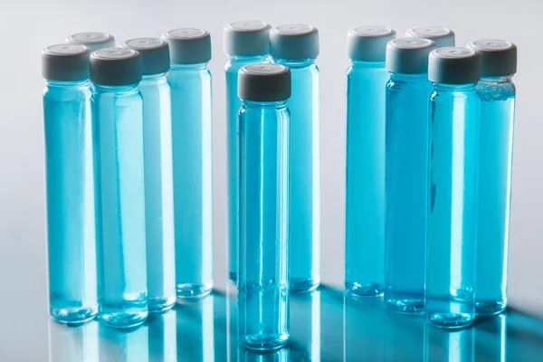 Garrafas com líquido azul — Fotografia de Stock