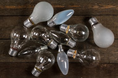 Lightbulbs on wooden background clipart